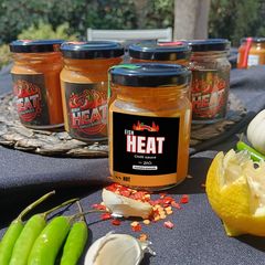 A jar of Eish Heat chilli sauce with green chillies, garlic, lemon and chilli flakes