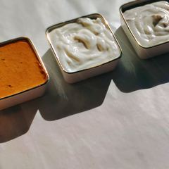Three house sauces in gold-rimmed bowls